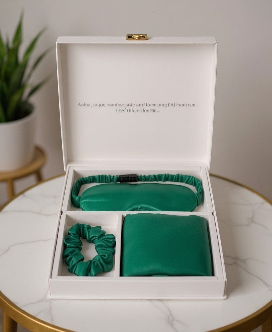 Everyday Gems luxury emerald green silk sleep gift set with eye mask, pillowcase, and scrunchie in a white box.
